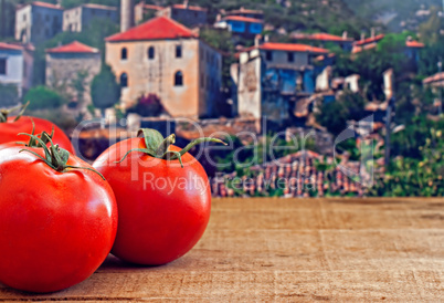 Red ripe tomatoes on rustic wooden table
