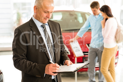 Caucasian salesman in car showroom