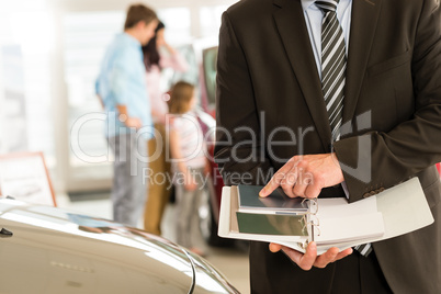 Car salesman's hands holding color swatches