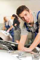 Portrait of mechanic repairing car