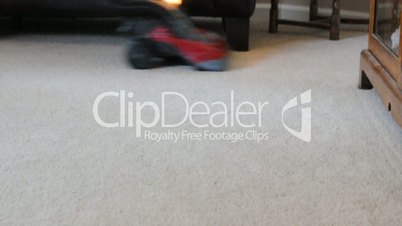 Vacuuming a room with red vacuum cleaner