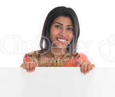 Indian woman holding blank billboard
