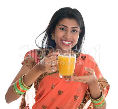 Indian woman in sari drinking orange juice