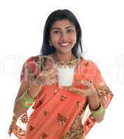 Indian woman in sari drinking milk