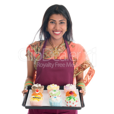 Traditional Indian woman baking bread and cupcakes