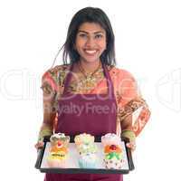 Traditional Indian woman baking bread and cupcakes