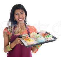Traditional Indian woman baking cupcakes
