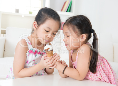 Children eating ice cream cone