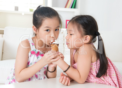 Asian kids eating ice cream cone