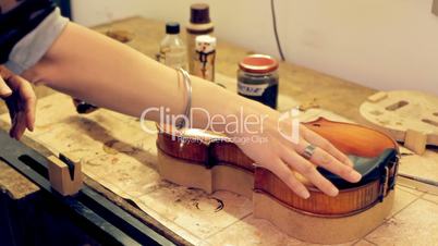 Music repair lab girl caressing violin