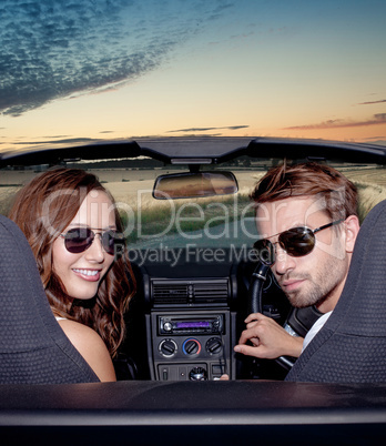 happy smiling couple in a convertible car. people outdoors.