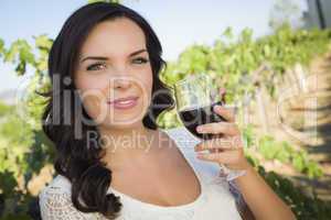 Young Adult Woman Enjoying A Glass of Wine in Vineyard