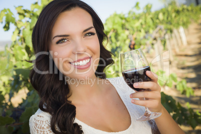 Young Adult Woman Enjoying A Glass of Wine in Vineyard