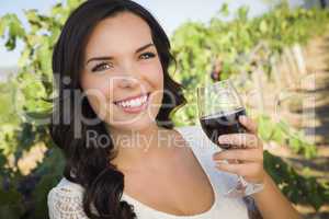 Young Adult Woman Enjoying A Glass of Wine in Vineyard