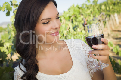 Young Adult Woman Enjoying A Glass of Wine in Vineyard