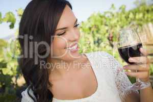 Young Adult Woman Enjoying A Glass of Wine in Vineyard