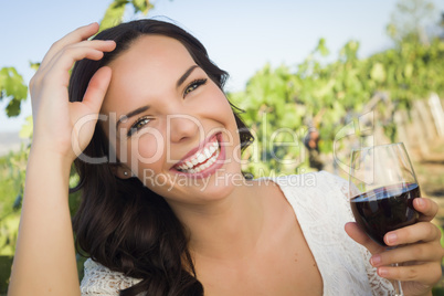 Young Adult Woman Enjoying A Glass of Wine in Vineyard