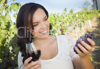 Young Adult Woman Enjoying A Glass of Wine in Vineyard