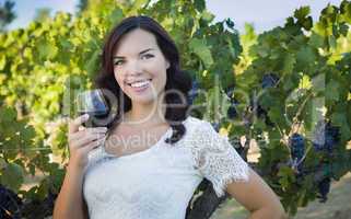 Young Adult Woman Enjoying A Glass of Wine in Vineyard