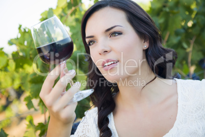 Young Adult Woman Enjoying A Glass of Wine in Vineyard