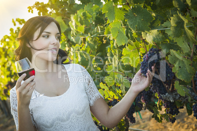 Young Adult Woman Enjoying A Glass of Wine in Vineyard