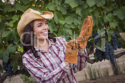 Young Adult Female Wearing Cowboy Hat and Gloves in Vineyard