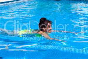 Middle-aged woman swims in the swimming pool