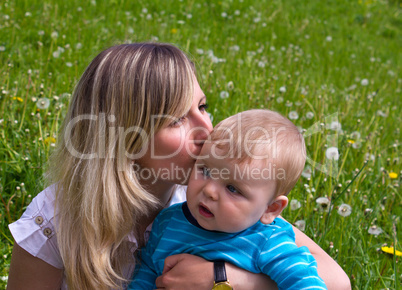 young mother kisses her little son