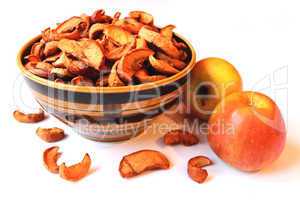 dried and fresh apples in the plate and besides it