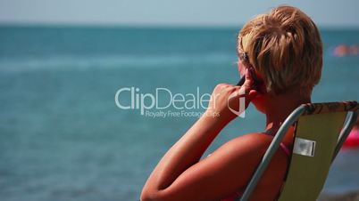 Woman Talking on the Phone at the Beach