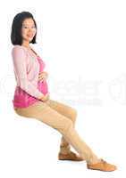 Pregnant Asian woman sitting