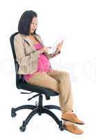 Pregnant Asian business woman using digital computer tablet pc