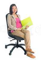 Pregnant Asian business woman working