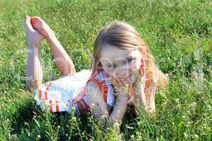 little girl lying on the grass