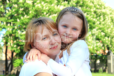 mother and daughter embrace one another