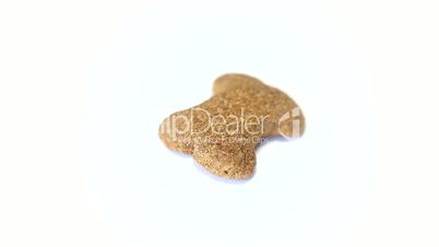 Dog food biscuit shaped like bones rotating