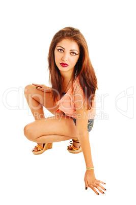 Girl crouching on floor.