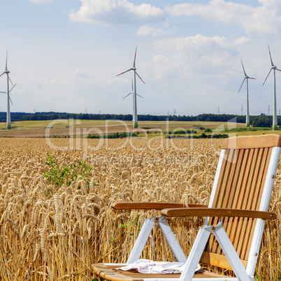 Garden chair in front of the corn field with windmills