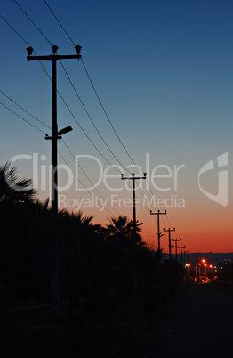 Electric power lines against a dawn sky