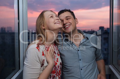 young happy couple on the balcony