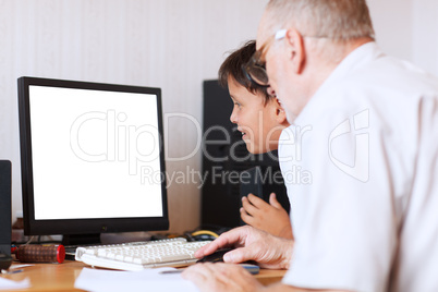 grandfather and grandson in front of the computer