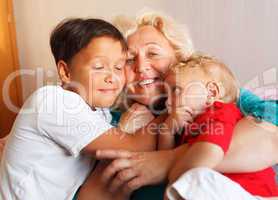 happy grandmother hugging with her grandsons