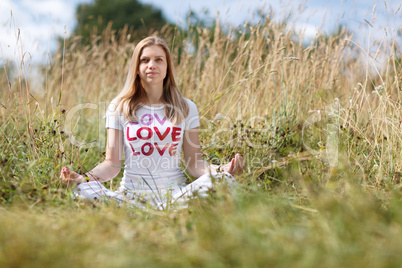 young girl meditating in the field
