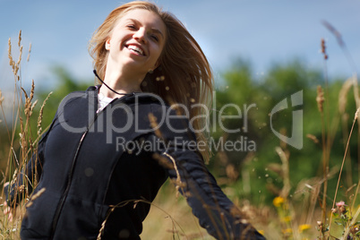 young happy girl running in the field