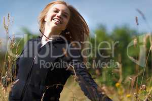 young happy girl running in the field