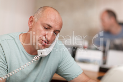 businessman talking on phone in office