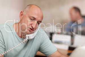businessman talking on phone in office