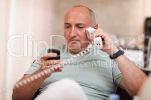businessman in the office speaking on two phones