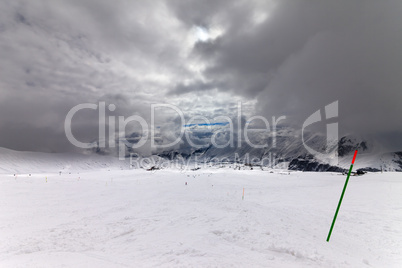 slope for slalom and sky with storm clouds