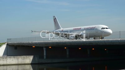 Tunisair airplane on taxiway bridge 11033
